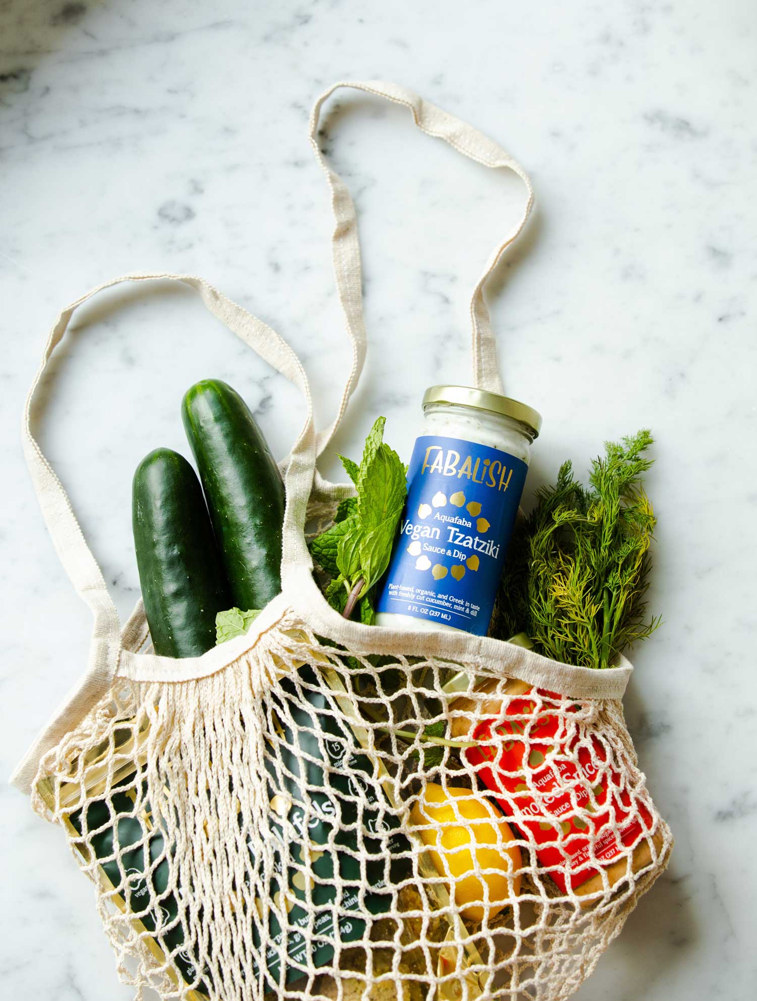 A tote bag filled with groceries. The groceries we buy can contribute to deforestation, the depletion of fish stocks, or the degradation of agricultural soils which is countering rewilding efforts.