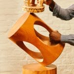 wooden sustainable stool being held by man