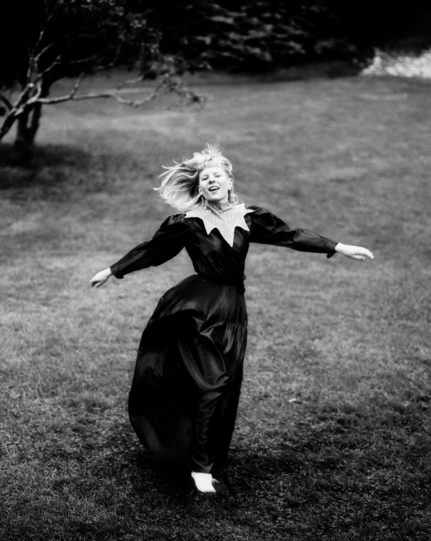 Black and white photo of Aksnes running on a lawn
