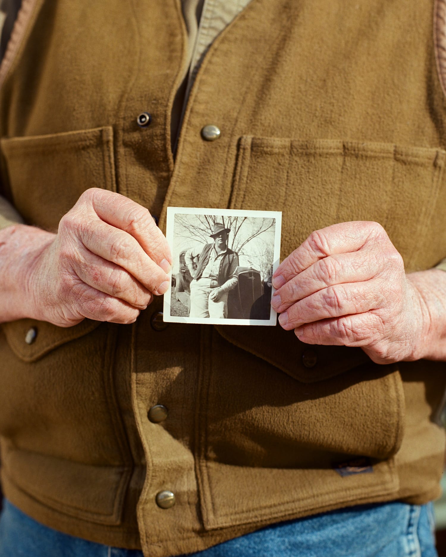 Will Harris of White Oak Pastures holding up an old photograph of his father