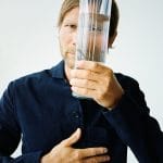 Chef and part-owner of restaurant Geranium in Copenhagen, Rasmus Kofoed, looking through a glass of water.